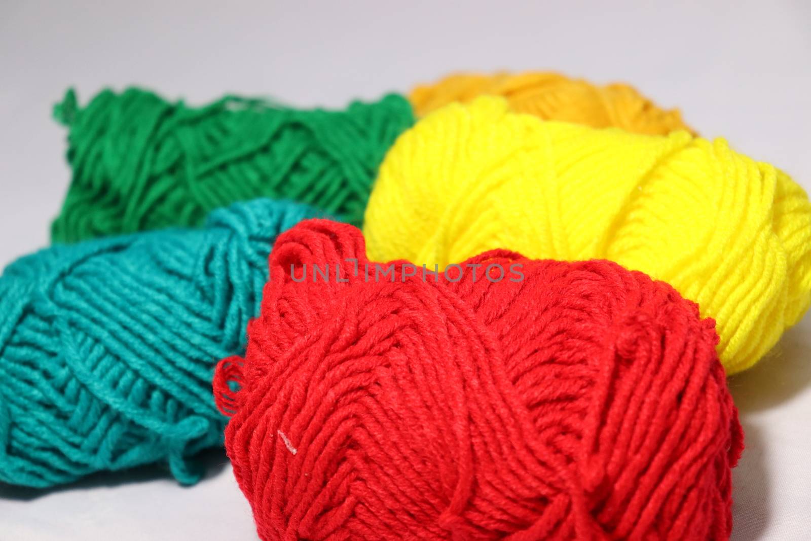 multiple colored yarn stock on white background