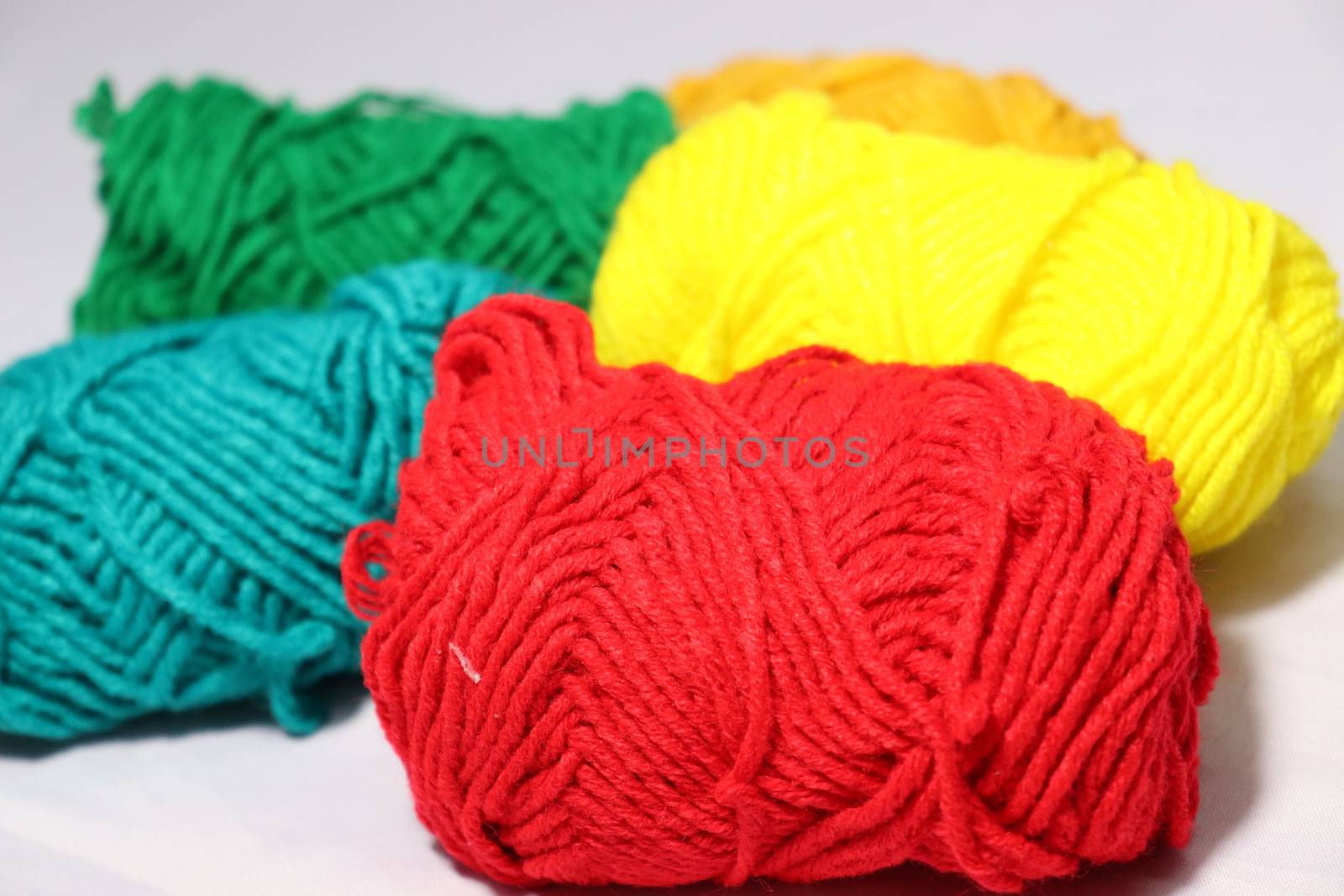 multiple colored yarn stock on white background