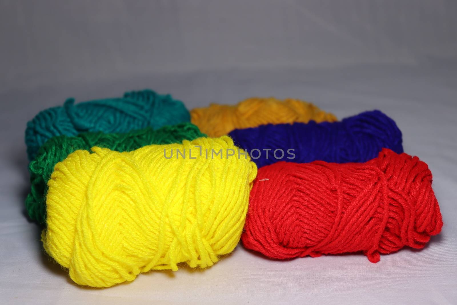 multiple colored yarn stock on white background