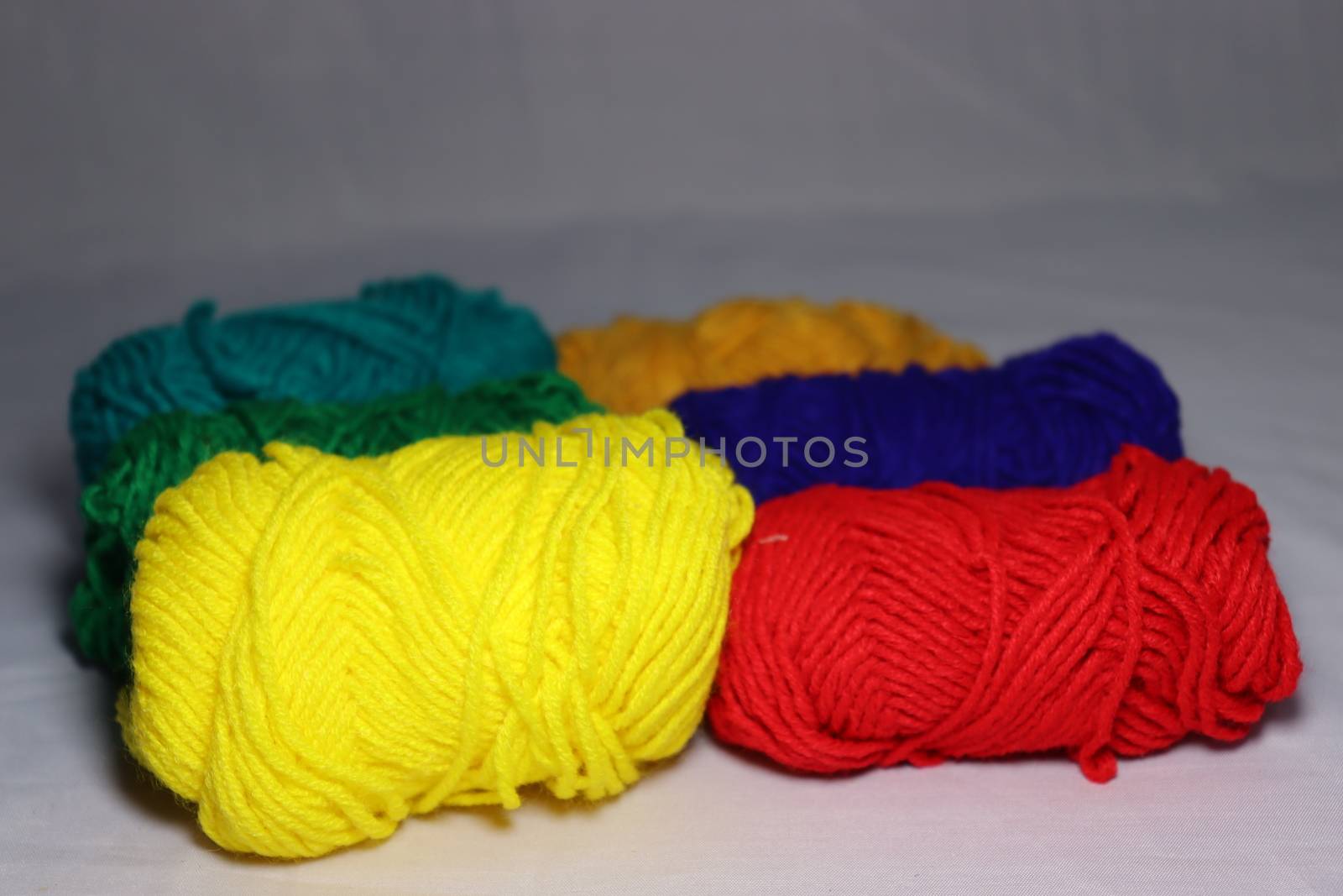 multiple colored yarn stock on white background