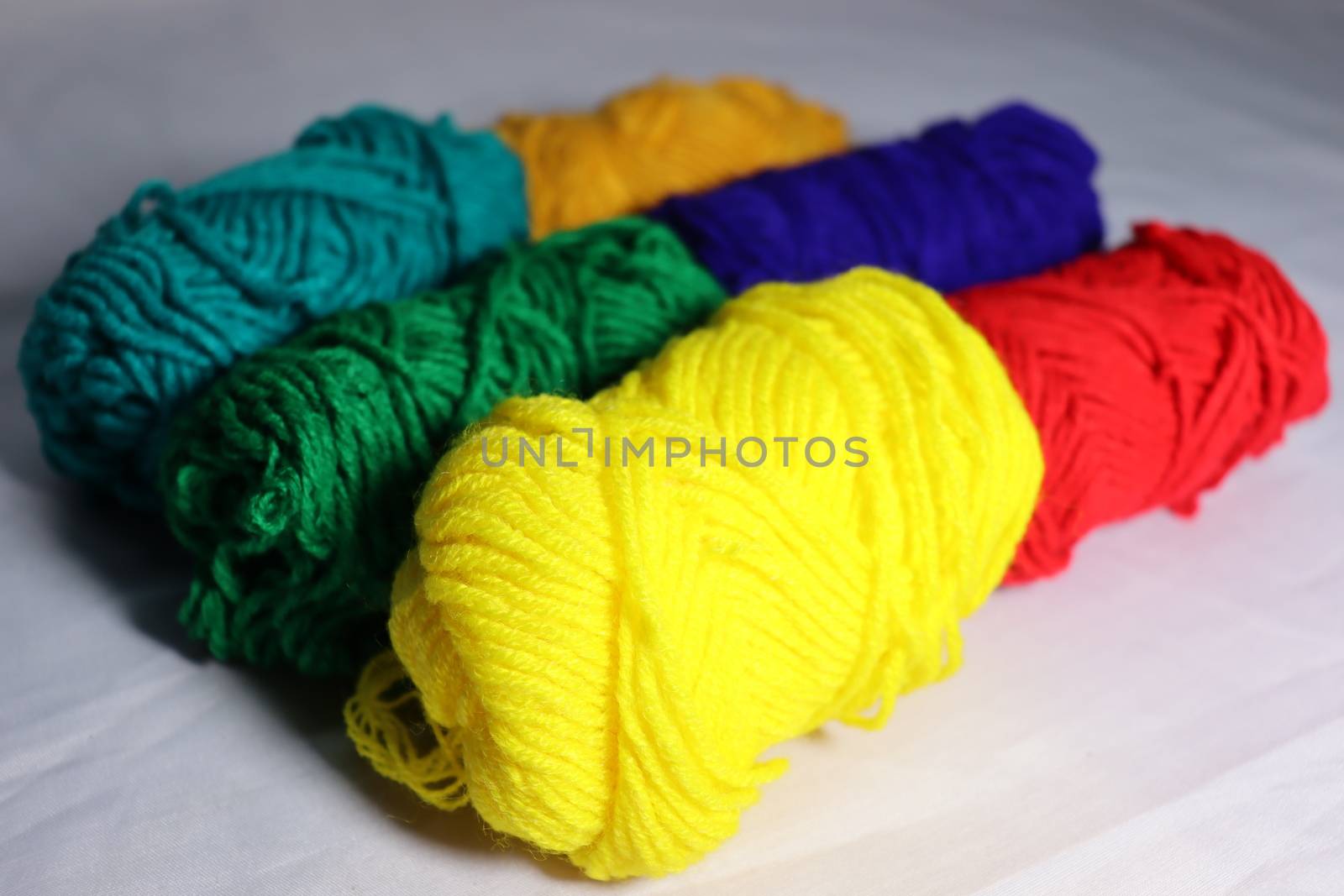 multiple colored yarn stock on white background