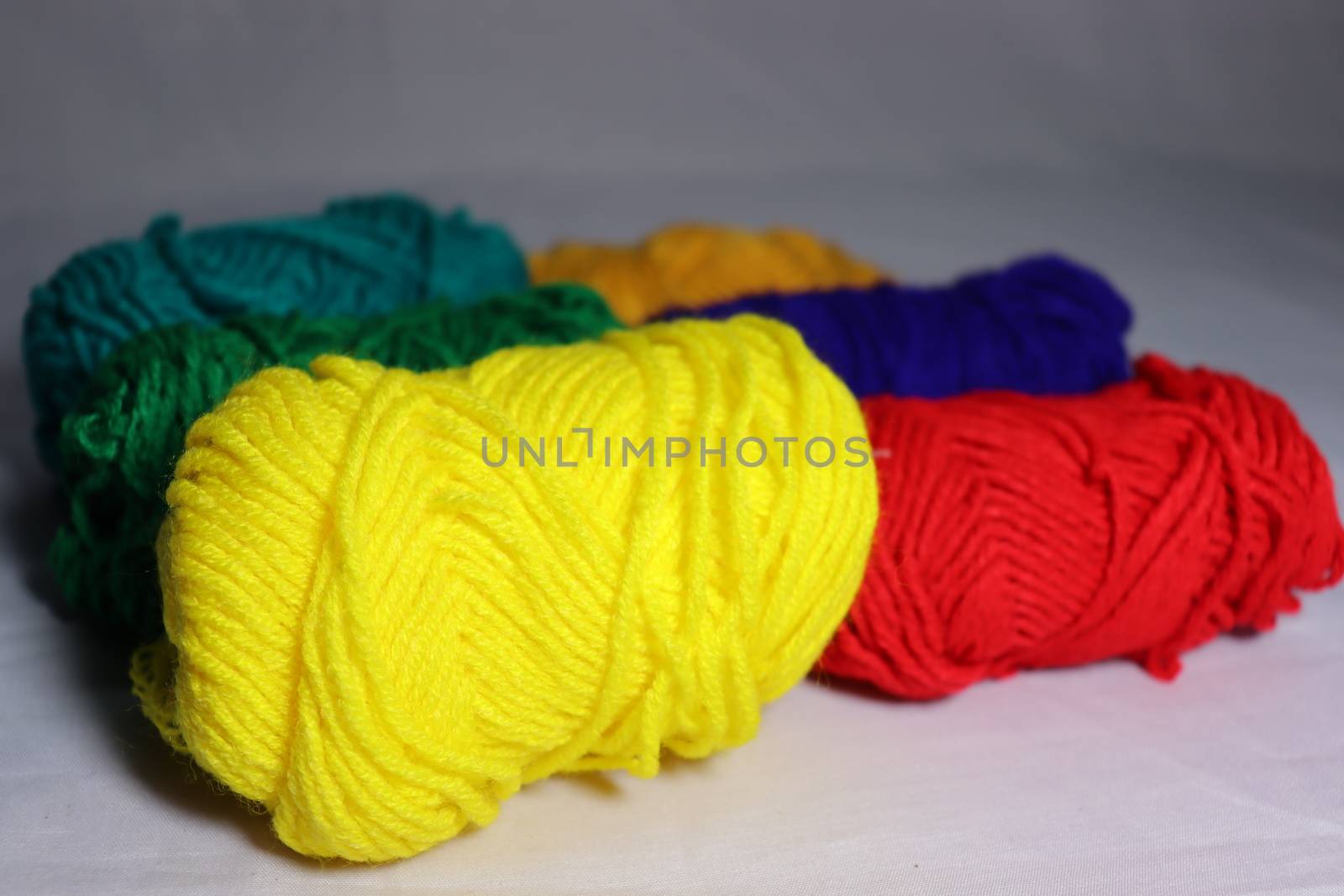multiple colored yarn stock on white background
