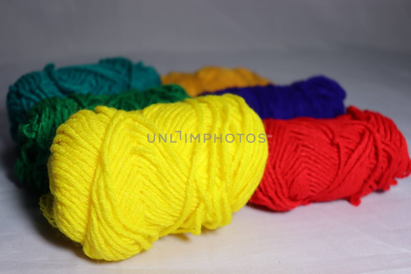 multiple colored yarn stock on white background
