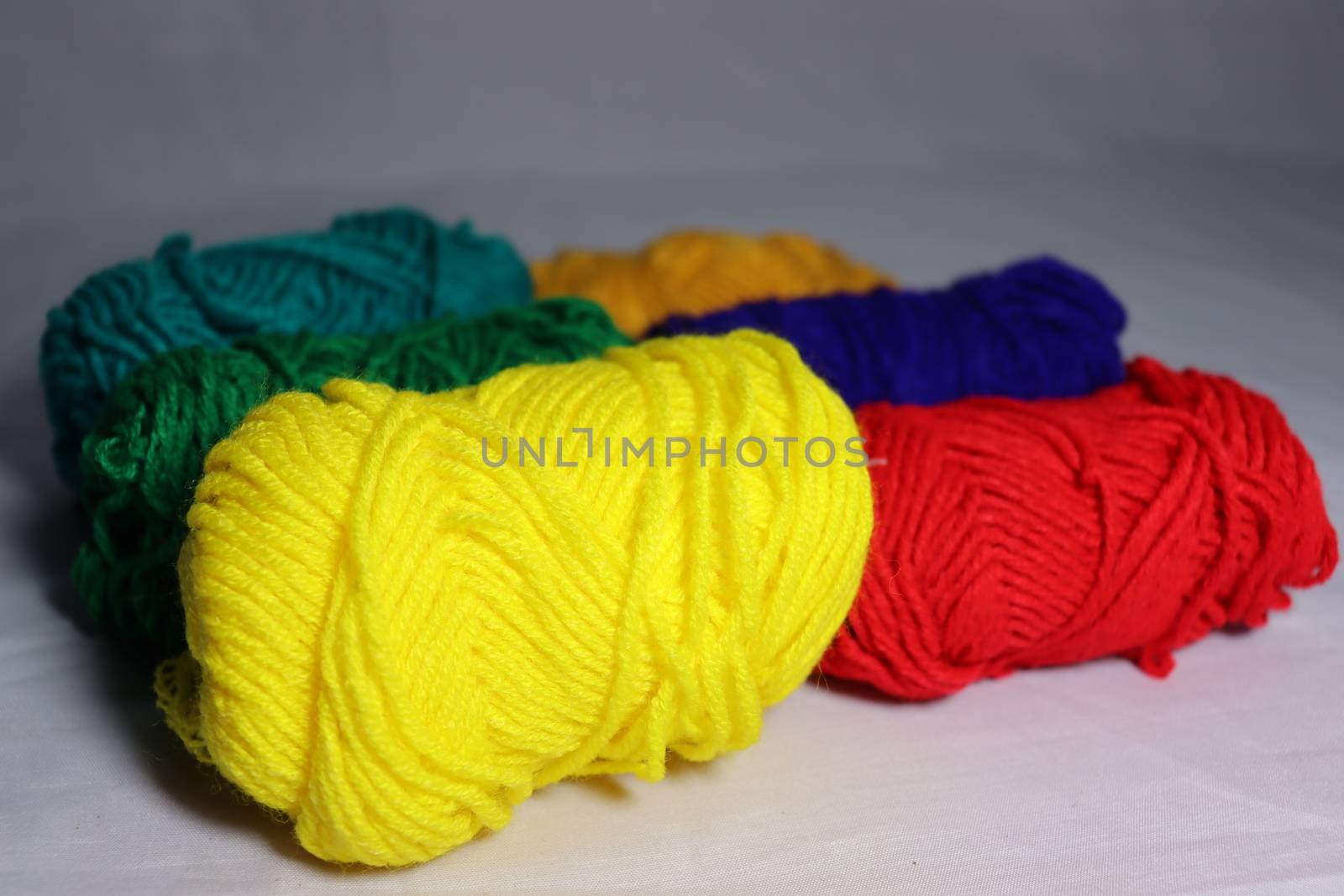 multiple colored yarn stock on white background