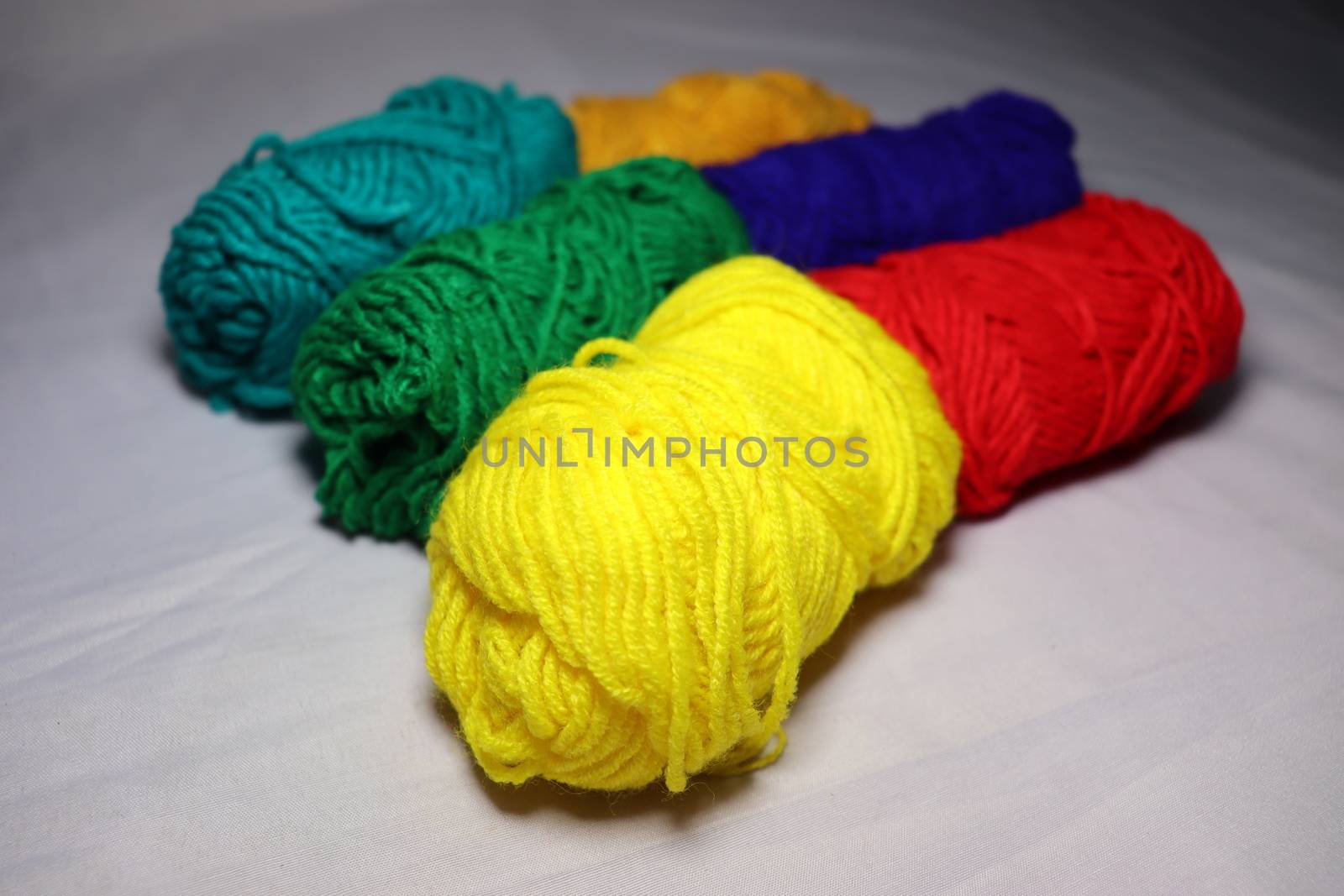 multiple colored yarn stock on white background