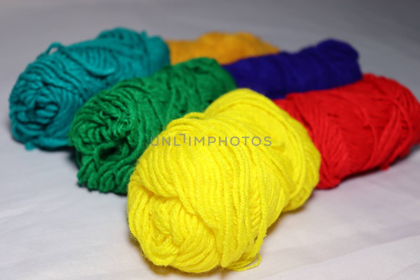 multiple colored yarn stock on white background