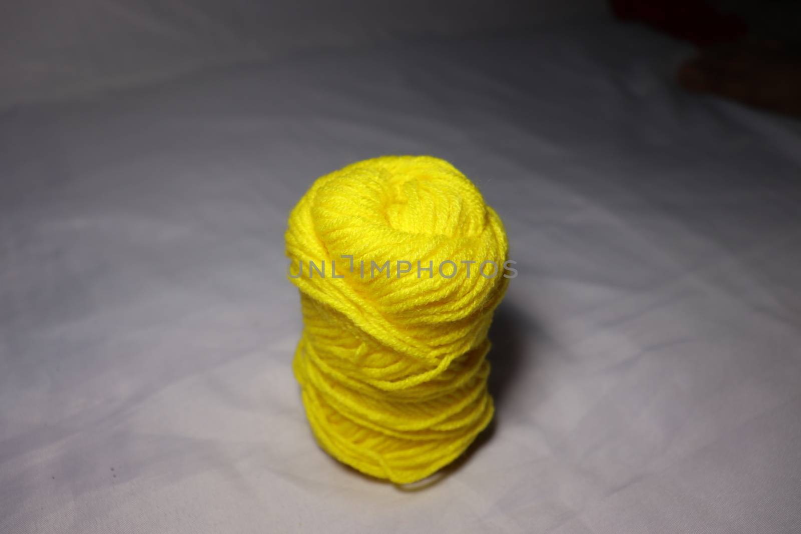 yellow colored yarn closeup on white background