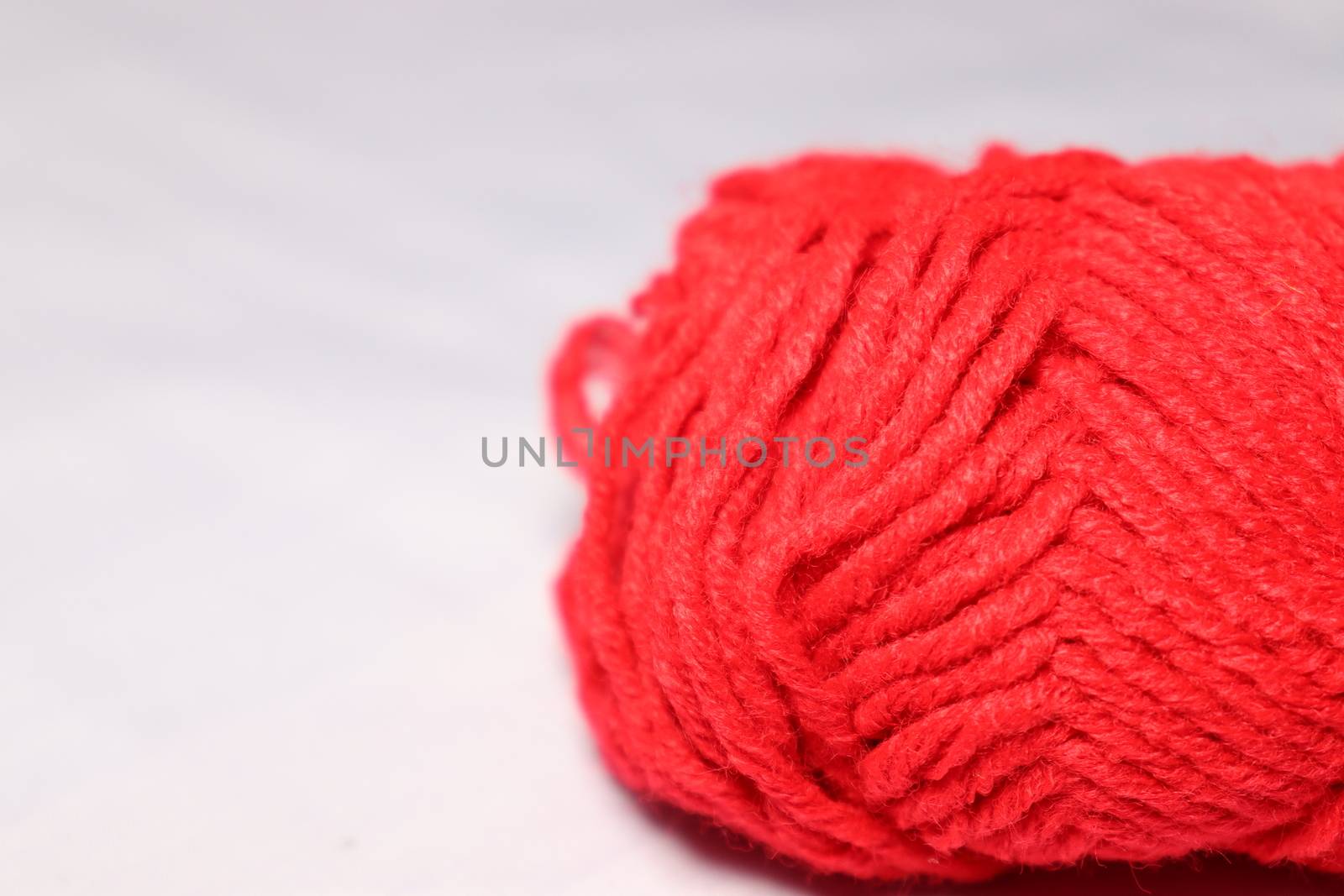 red colored yarn closeup on white background
