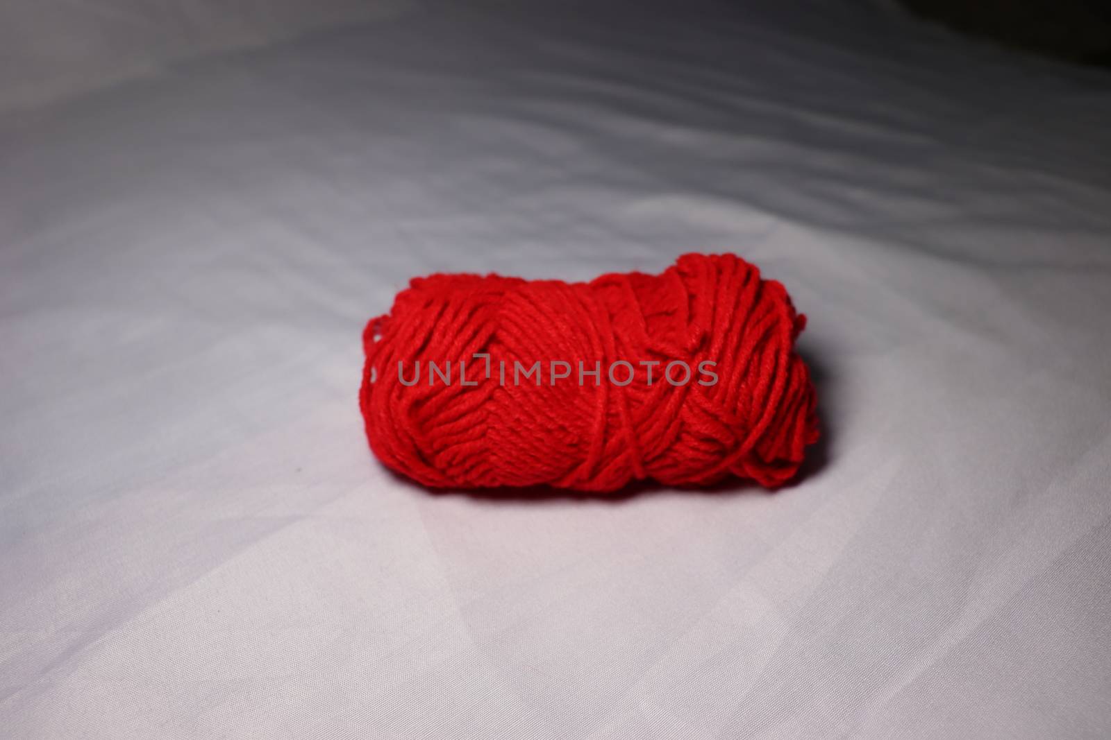 red colored yarn closeup on white background
