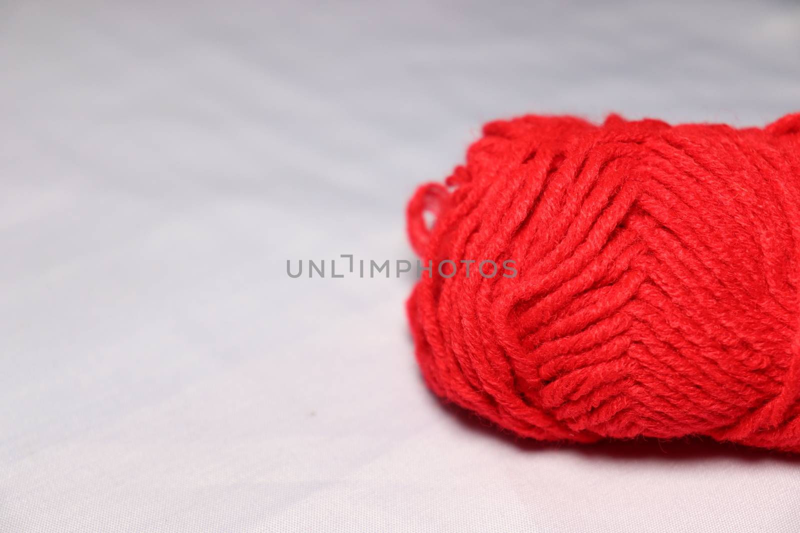 red colored yarn closeup on white background