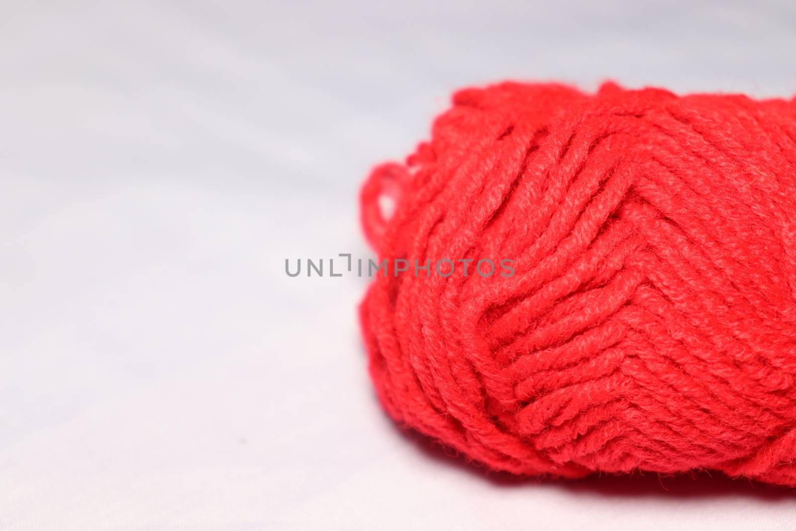 red colored yarn closeup on white background