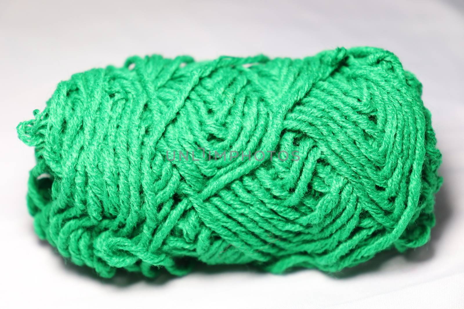 green colored yarn closeup on white background