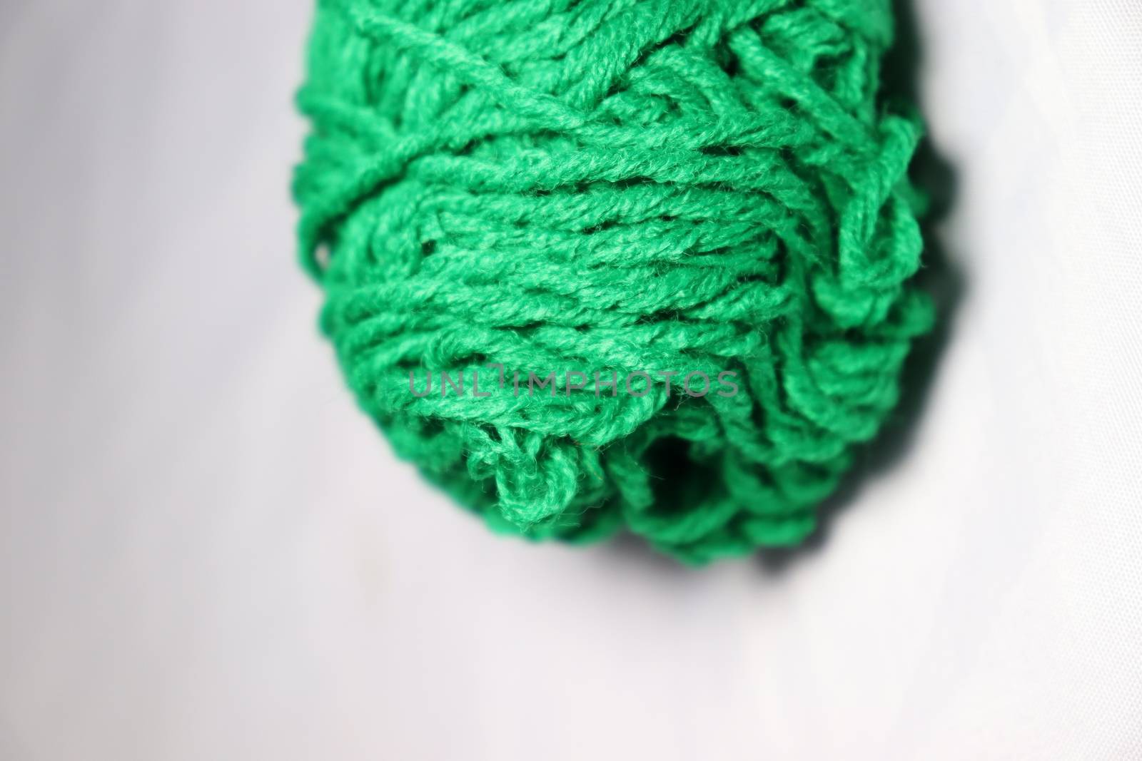 green colored yarn closeup on white background