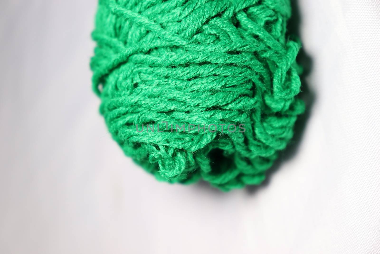 green colored yarn closeup on white background