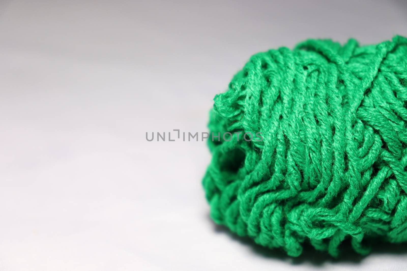 green colored yarn closeup on white background