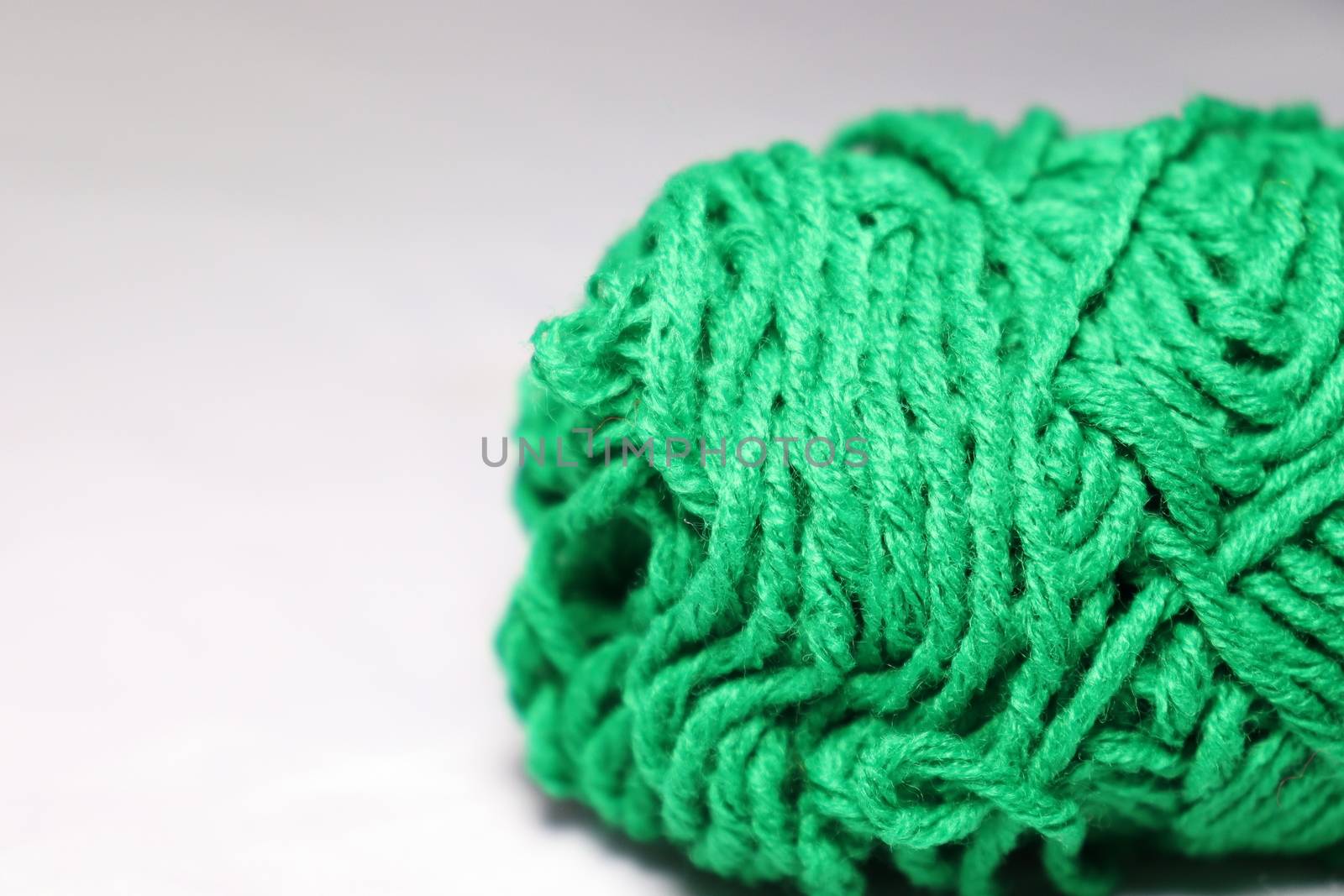 green colored yarn closeup on white background