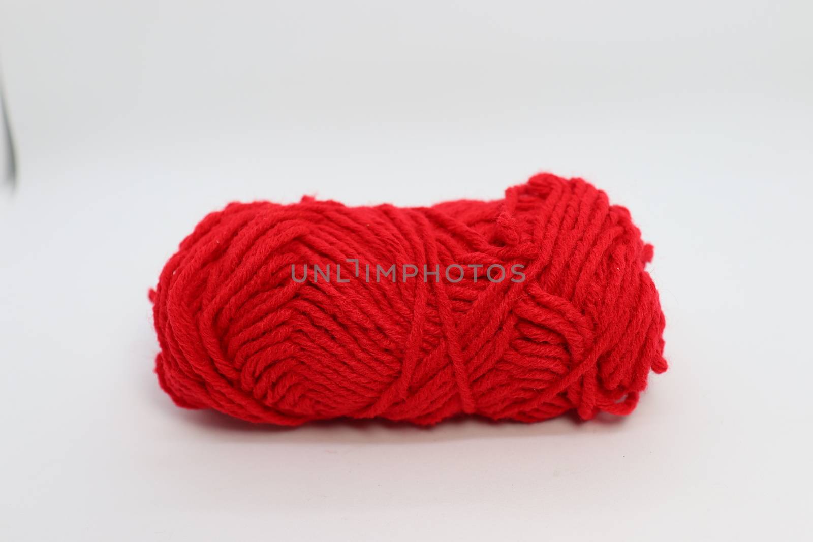 red colored yarn closeup on white background
