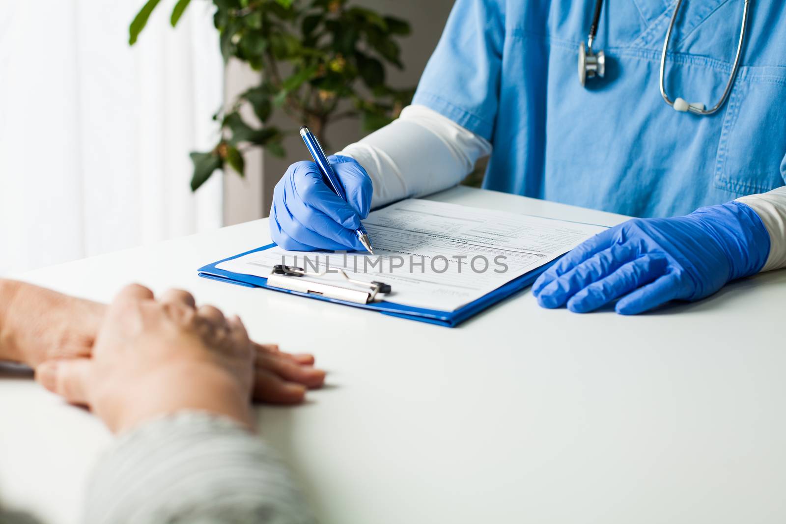 General Practitioner completing patient examination in doctor's office,filling out medical card form,diagnostic consultation & prevention of women's diseases,medical service,healthy lifestyle concept