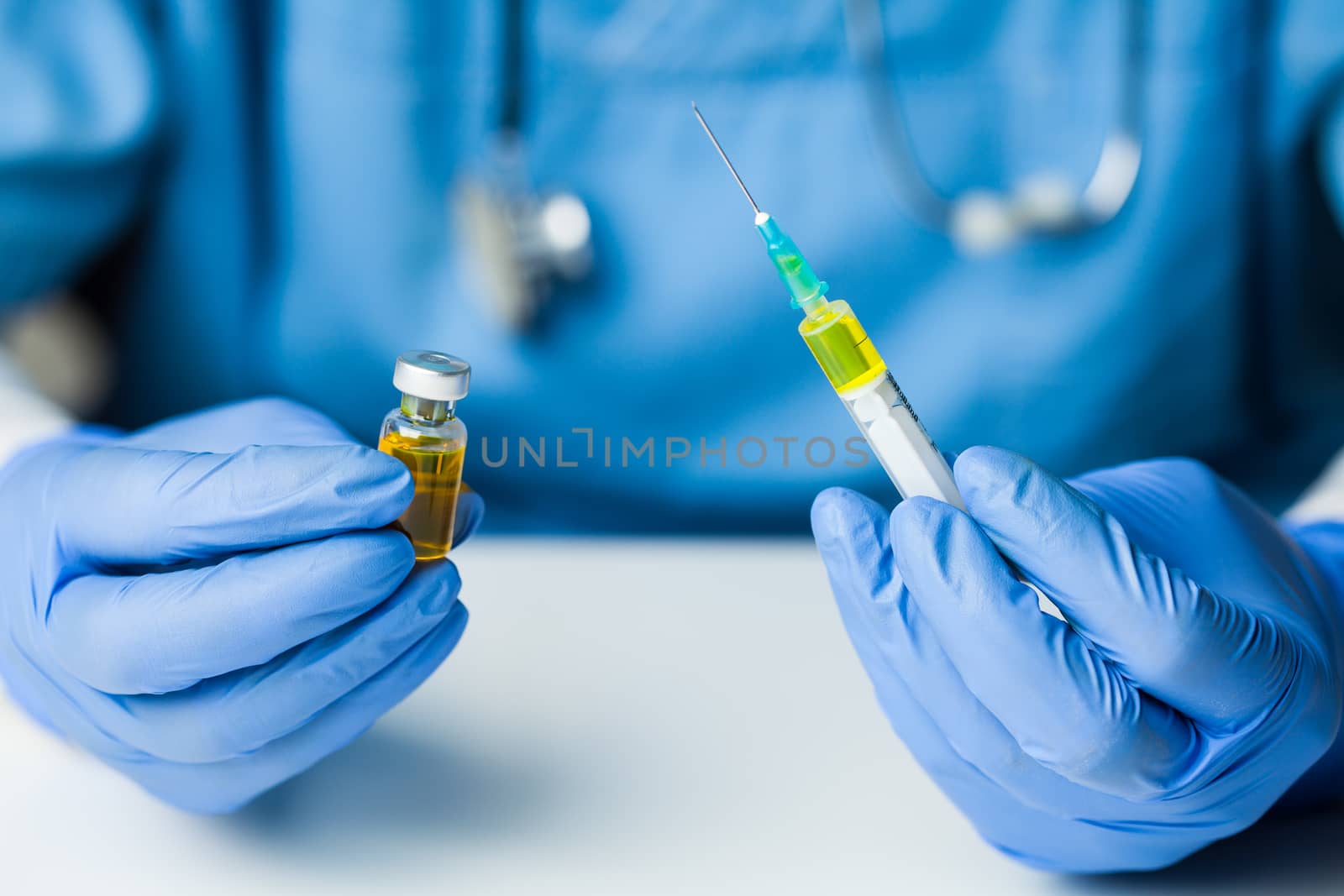 Coronavirus COVID-19 vaccine development,research for cure & treatment of infected patients,groundbreaking discovery in battle against SARS-CoV-2 pathogen,hands in gloves holding ampoule & syringe jab