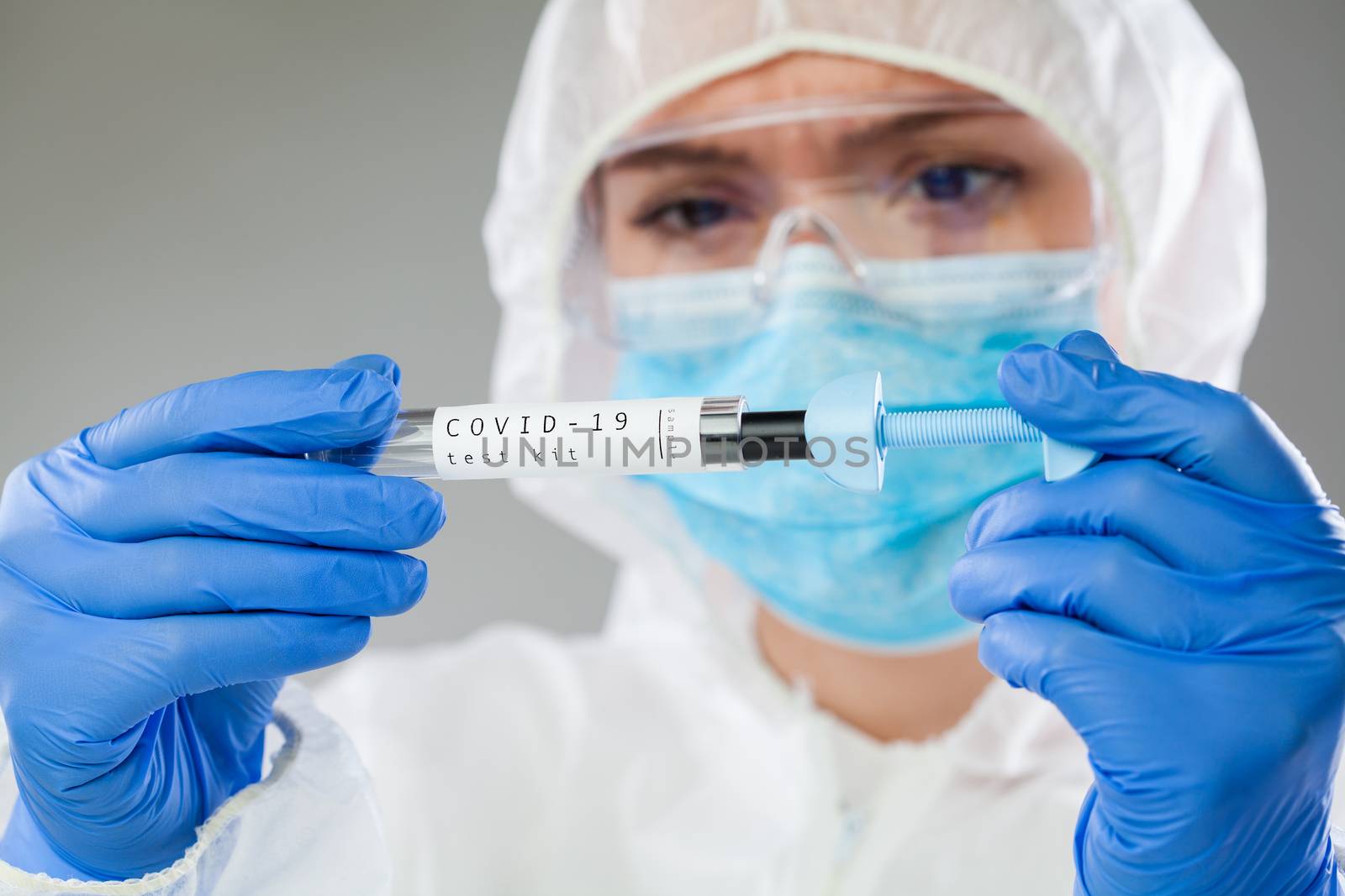Healthcare professional holding Coronavirus COVID-19 test kit eq by Plyushkin