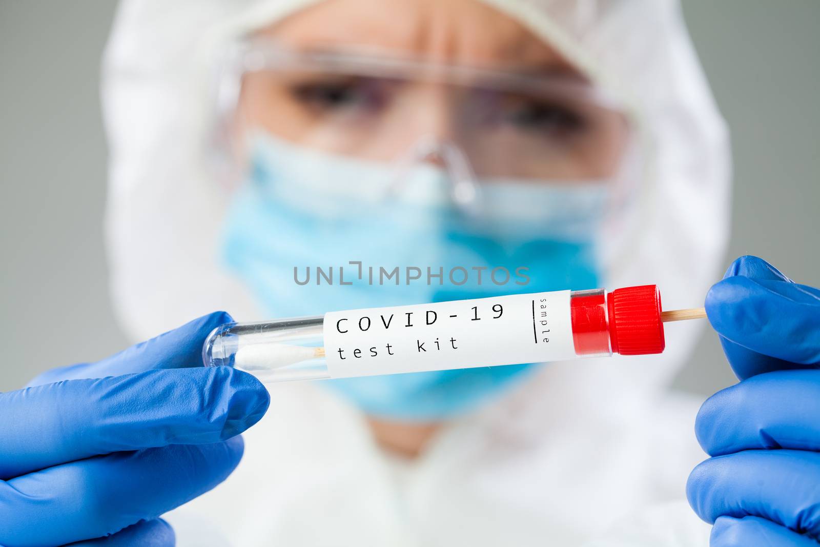 Medical healthcare technologist holding COVID-19 swab collection kit,wearing white protective suit mask and gloves,test tube for taking OP NP patient specimen sample,PCR DNA test process illustration