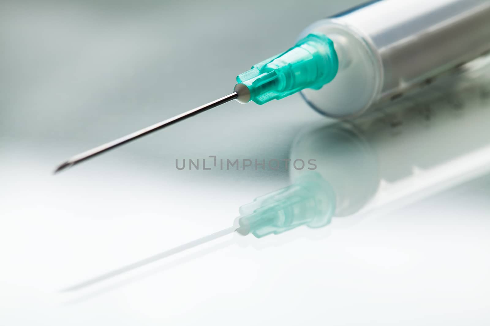 Injection shot, needle & syringe jab on reflective surface,COVID-19 Coronavirus pandemic search for potential vaccine cure,vaccination concept illustration