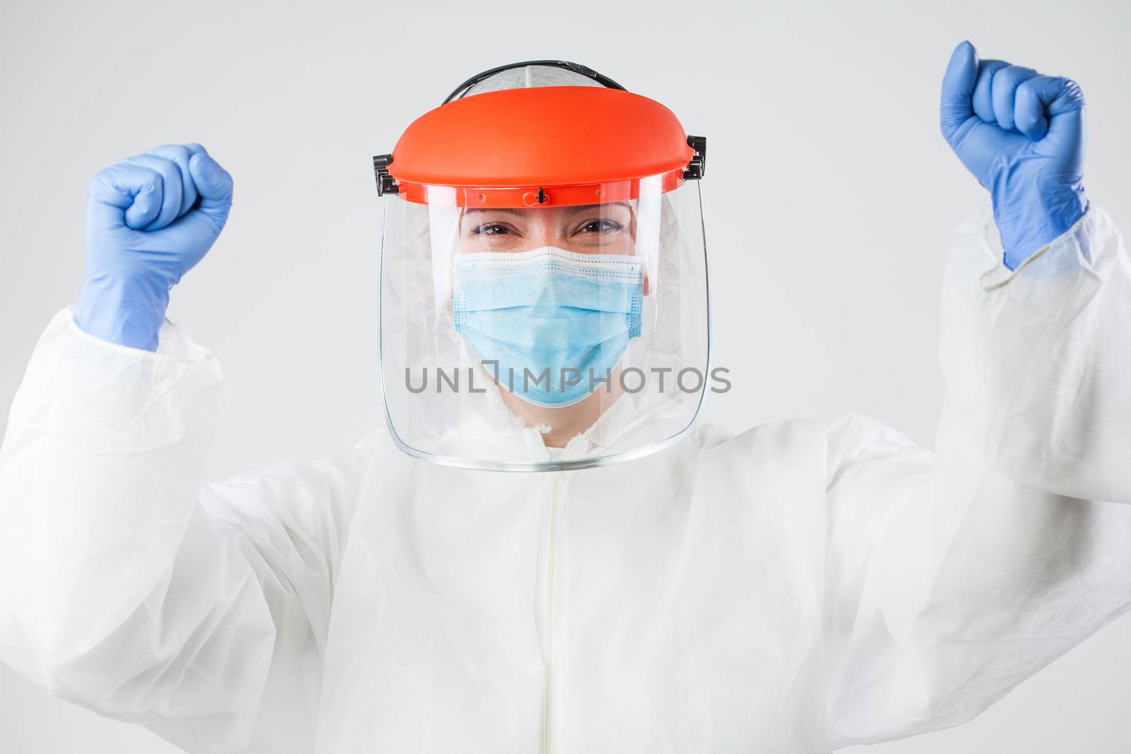 Victorious doctor or nurse in personal protective equipment by Plyushkin