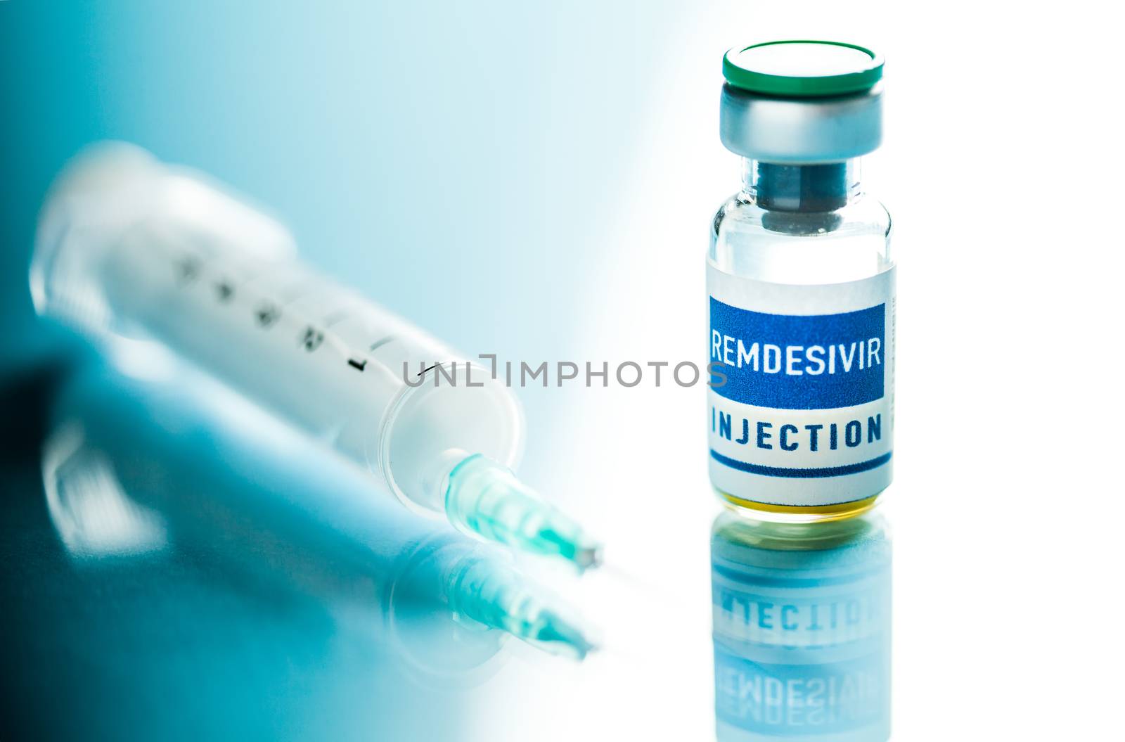 REMDESIVIR injection ampoule with syringe & needle,isolated on reflective glass surface,potential FDA experimental trial drug for treating Coronavirus COVID-19 virus disease cases,pandemic crisis cure