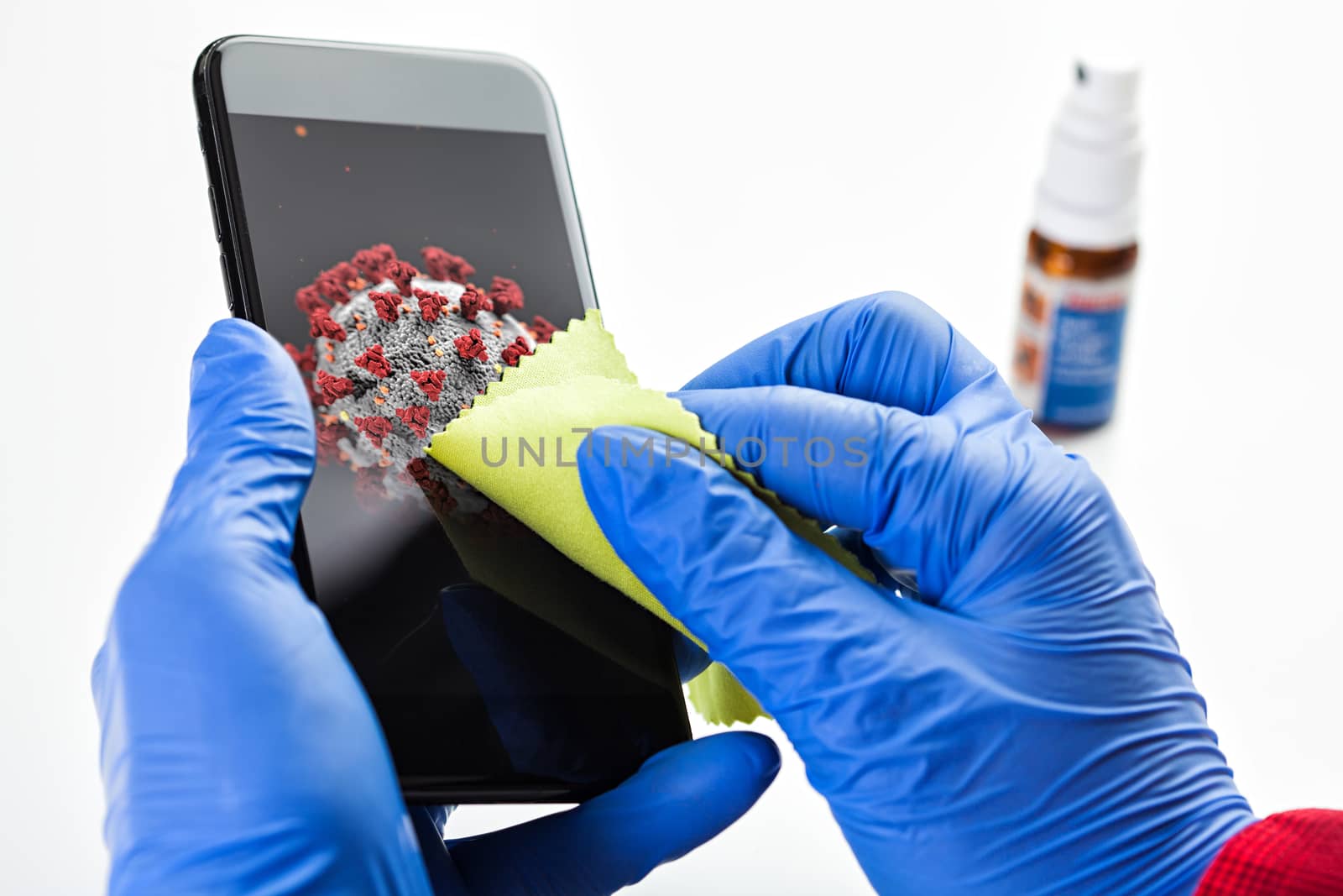 Hand in gloves wiping cellphone screen with green cloth, illustration of Coronavirus COVID-19 virus disease infection spread prevention and protection,global pandemic outbreak cautionary measures 