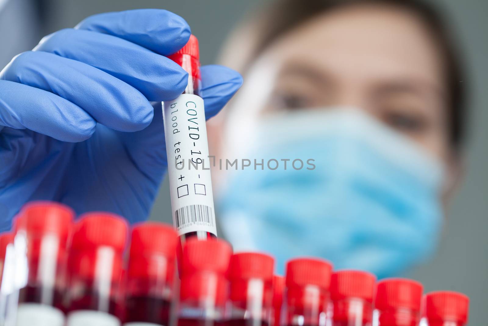 Doctor pulling out a test tube with Coronavirus patient blood sample ready for laboratory examination, global pandemic of deadly COVID-19 corona virus disease, hematology testing process illustration