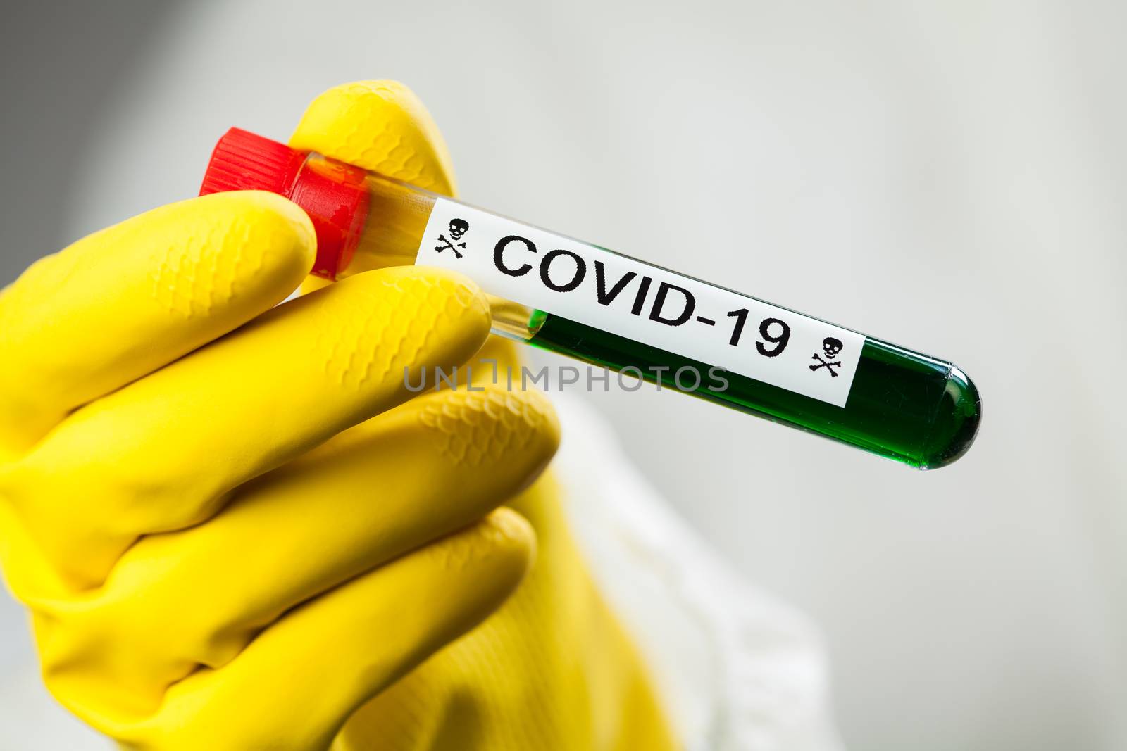 Lab scientist or medical technologist holding test tube with Coronavirus COVID-19 toxic green liquid, science fiction illustration of deadly corona virus, global pandemic crisis outbreak, cure vaccine