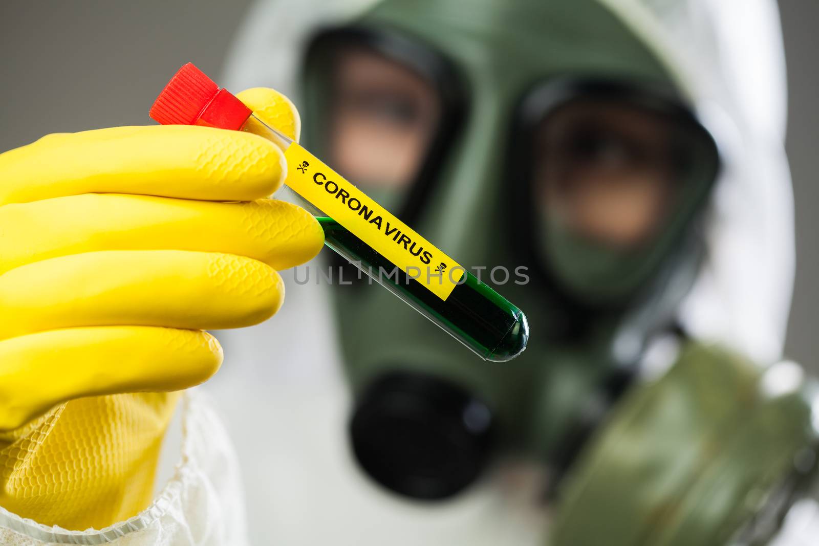Lab scientist or medical researcher holding CORONAVIRUS test tube containing deadly liquid,science fiction illustration of toxic poisonous substance,COVID-19 virus disease global pandemic crisis