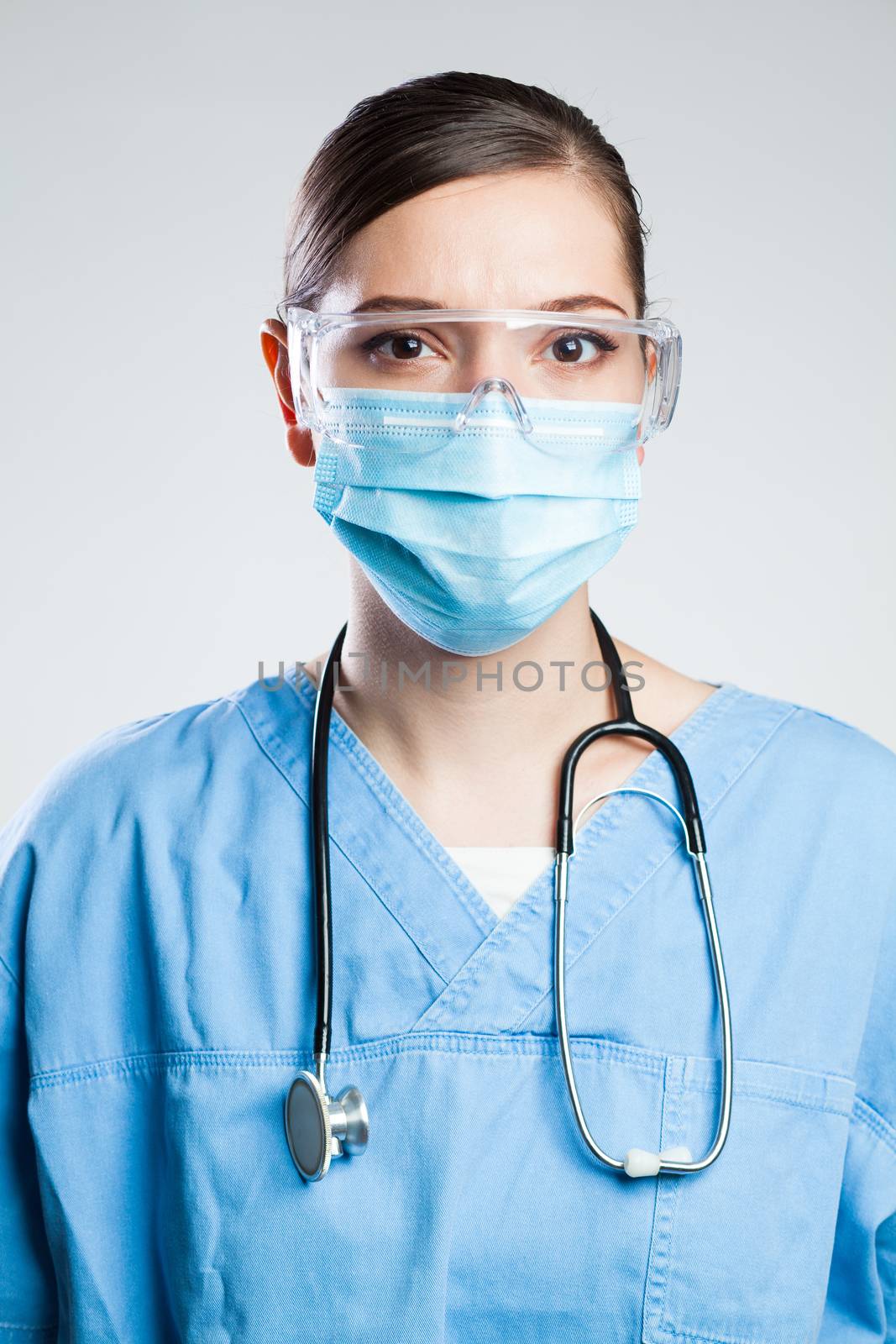 Young serious female EMS key worker doctor by Plyushkin