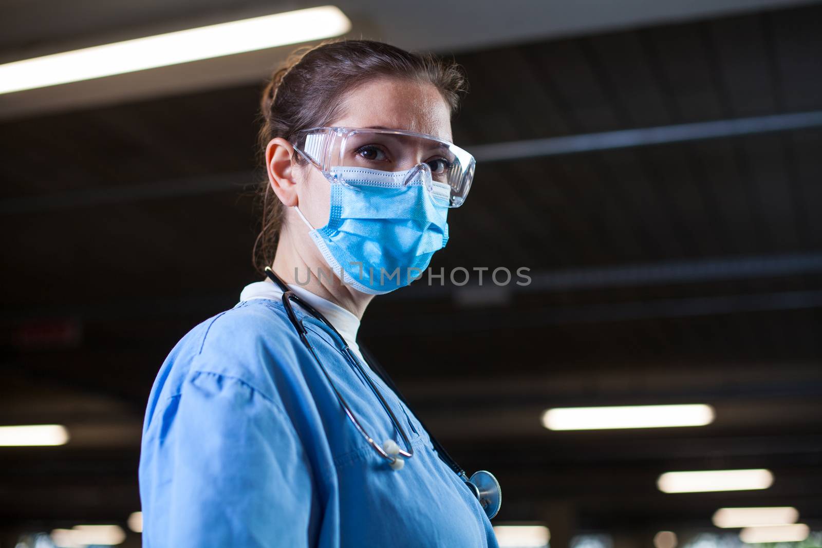Young female doctor in lab or hospital clinic by Plyushkin