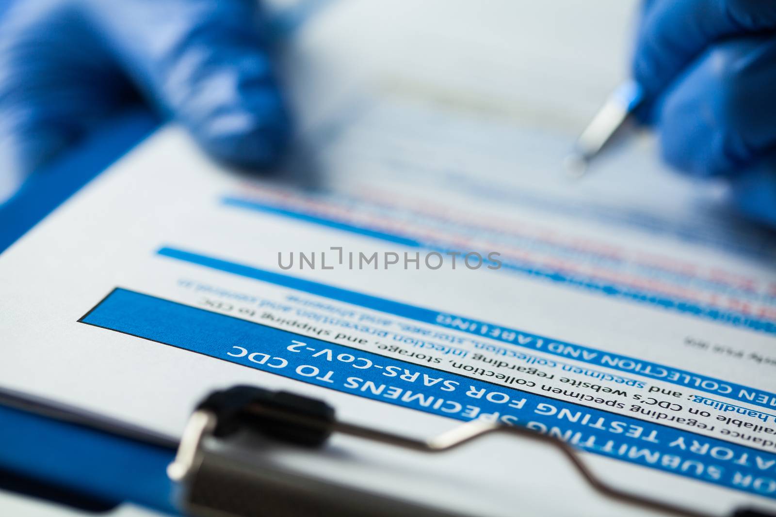 Laboratory technician checking CDC specimen submitting form by Plyushkin
