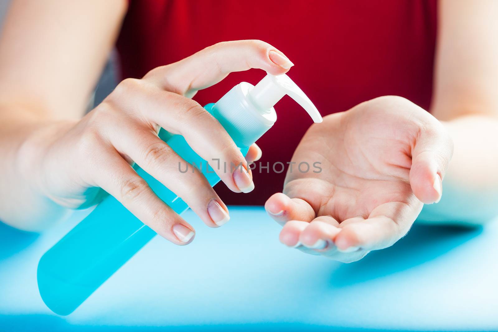 Caucasian woman applying dry hand wash sanitizer gel by Plyushkin