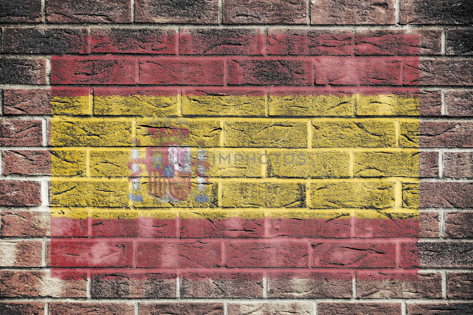 A Spain flag on a brick wall background
