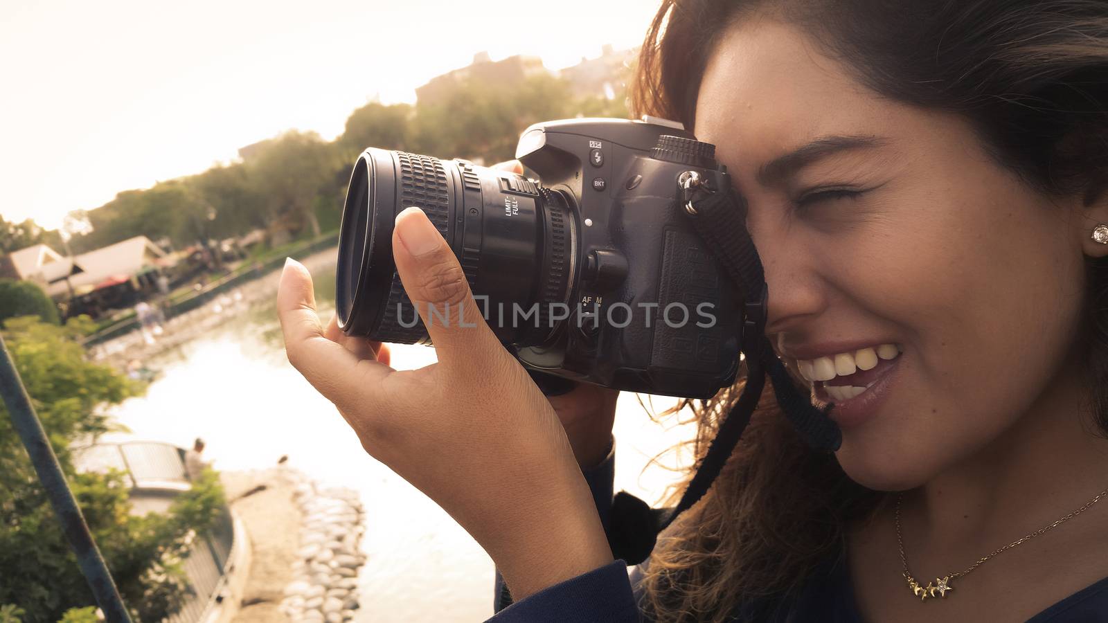 Outdoor summer smiling lifestyle portrait of pretty young woman having fun in the city of Lima taking pictures with her camera