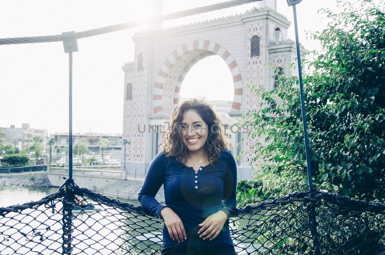 Portrait of a young woman enjoying and smiling in the park