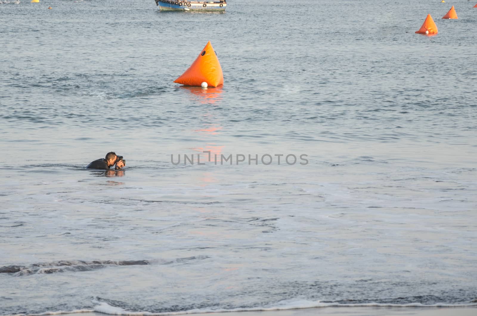 Photographer takes a photo of the fishing boat in the sea in Lima, Peru