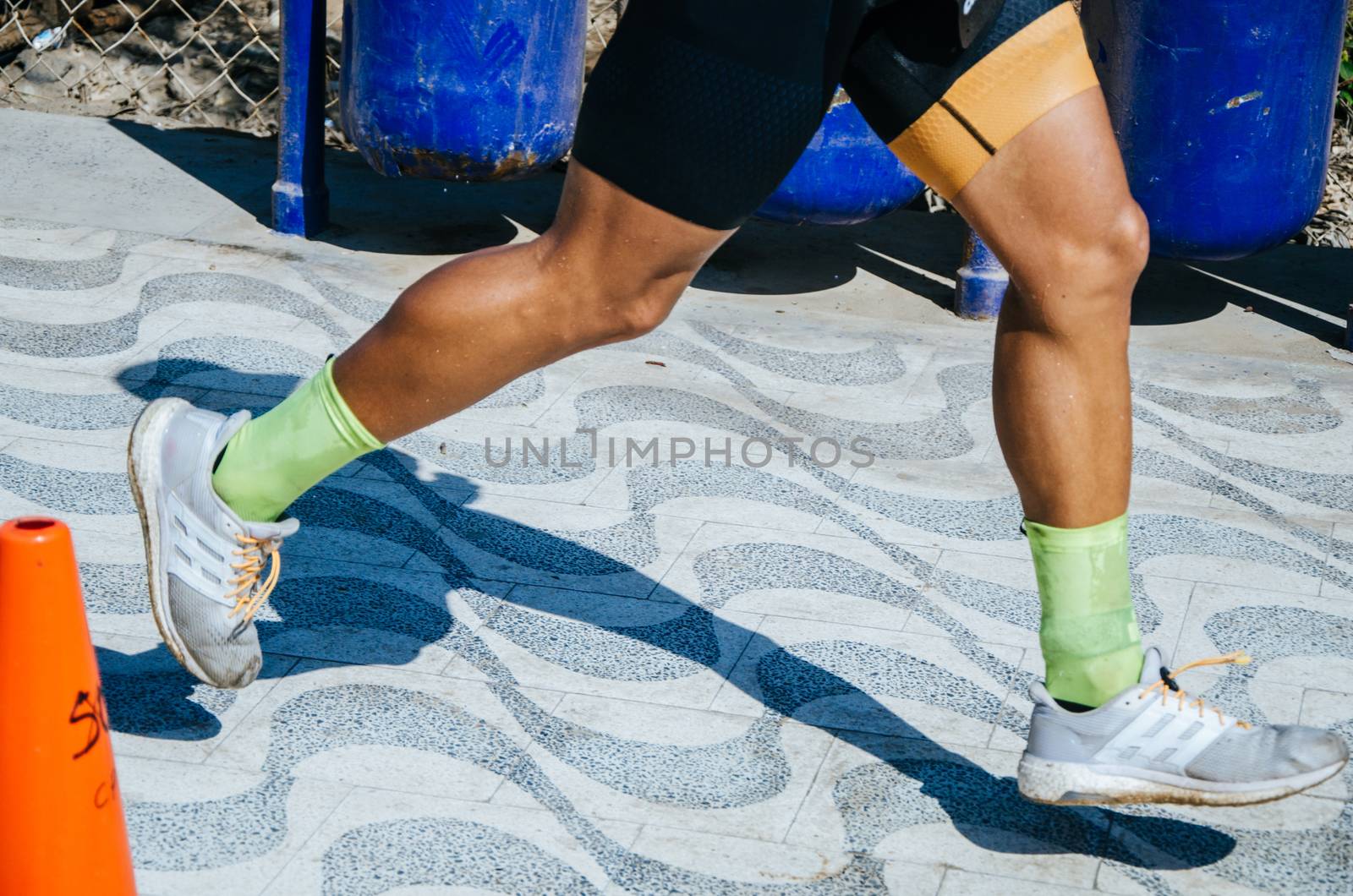 Sports background. Runner feet running on road closeup on shoe.