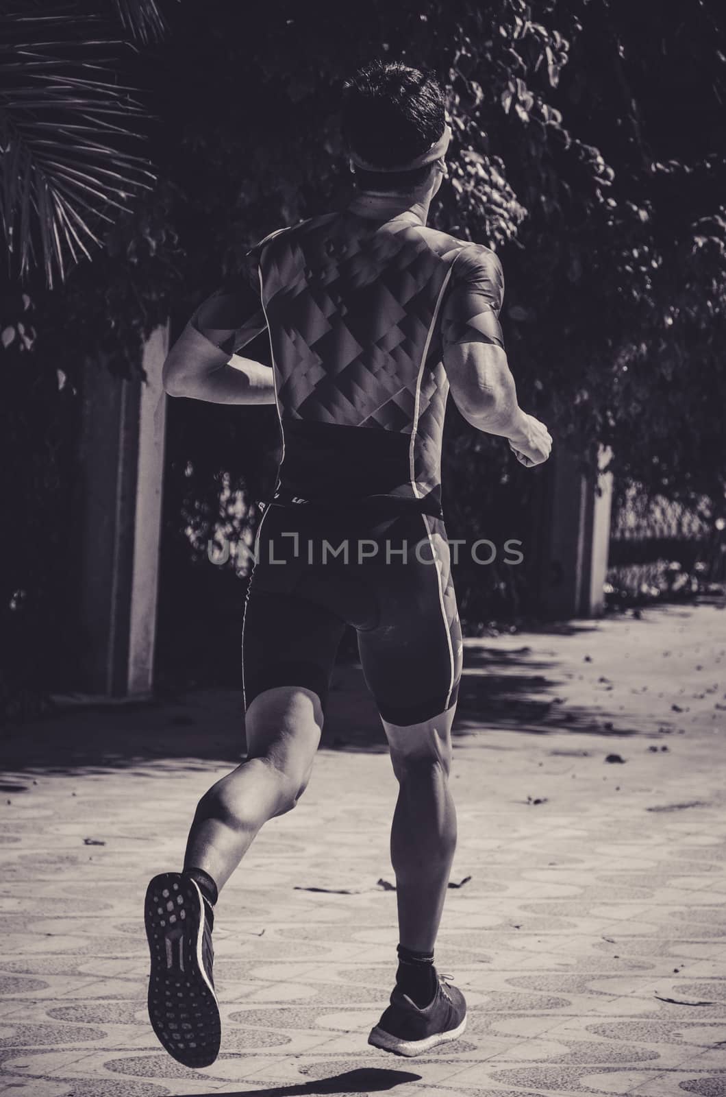 A man runner on the street doing exercises, image concept of sport and exercise