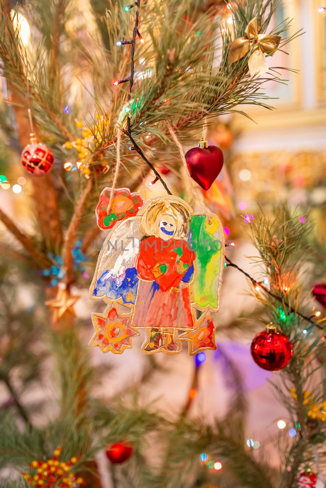 Decorated Christmas tree with toy angel in Orthodox church. Merry Christmas religious concept