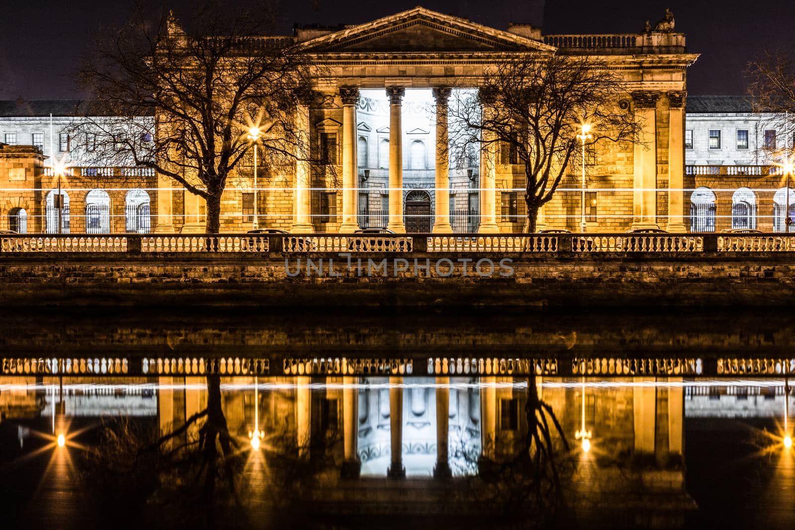 Night picture of the river liffey and Dublin Ireland Four Courts at the river liffey at night