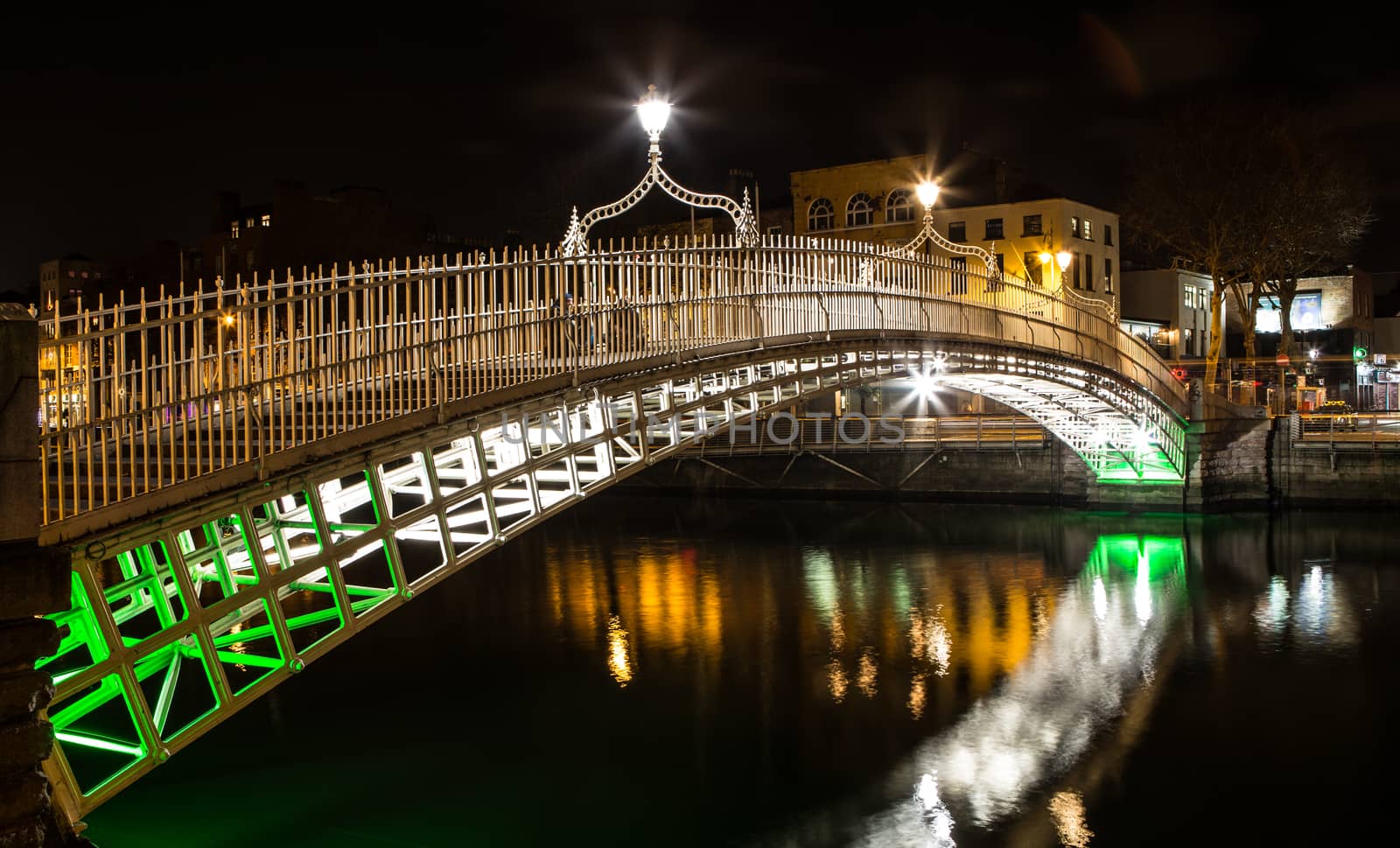 Night picture of the river liffey and Ha penny bridge Dublin Ireland reflections by mlechanteur