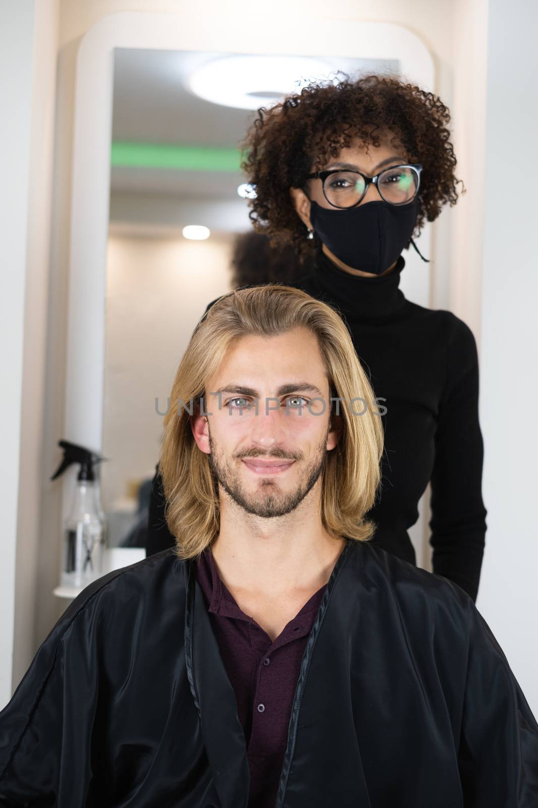 Handsome blonde male client getting haircut by black female hairdresser by Dumblinfilms