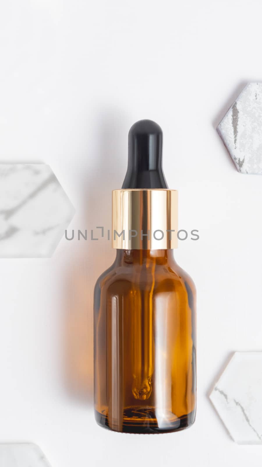 Top view on glass bottles of essential oil or cosmetic serum on by aksenovko