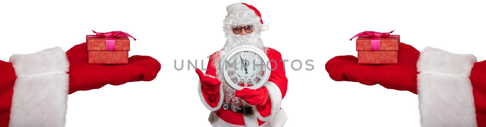 Santa Claus holding a white clock which shows five minutes to midnight. Two hands with gifts on them extended to him. New year's eve concept. Isolated on white background by DamantisZ