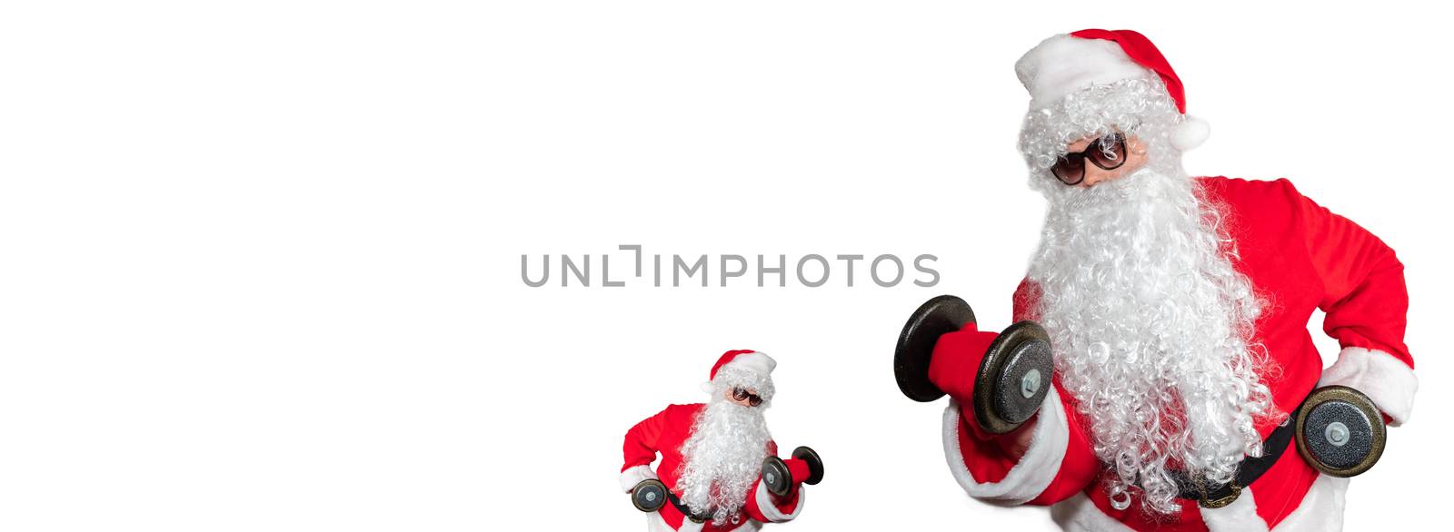 Santa Clauses working out, lifting dumbbells and doing bicep curls. One little santa facing a big santa. Isolated on white background. Sport, fitness, bodybuilding conept. Banner size, copy space.