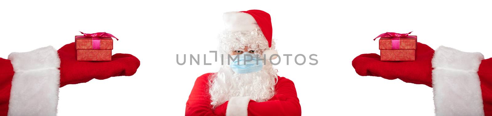 Santa Claus wearing a medical mask and has his arms crossed on his chest, looks very angry. Two hands with gifts extended to him on both sides. Isolated on white background. Banner size, copy space by DamantisZ